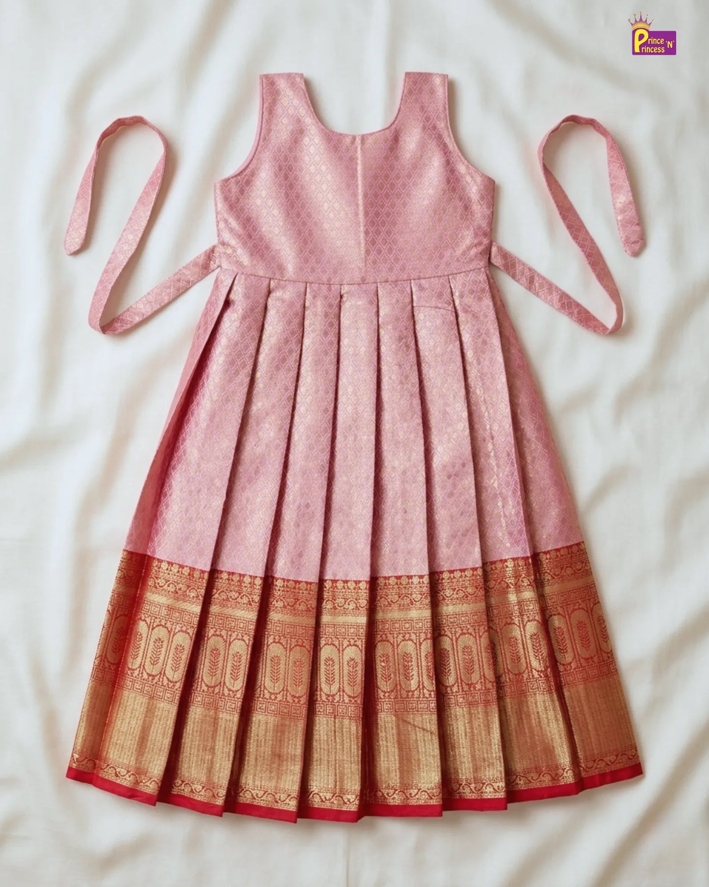 Pink dress with a patterned bottom section on a white background