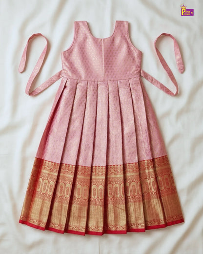 Pink dress with a patterned bottom section on a white background