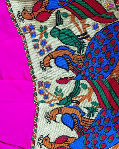 Colorful embroidered fabric with peacock design on a pink background