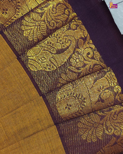 Close-up of a fabric with intricate gold pattern on a purple background