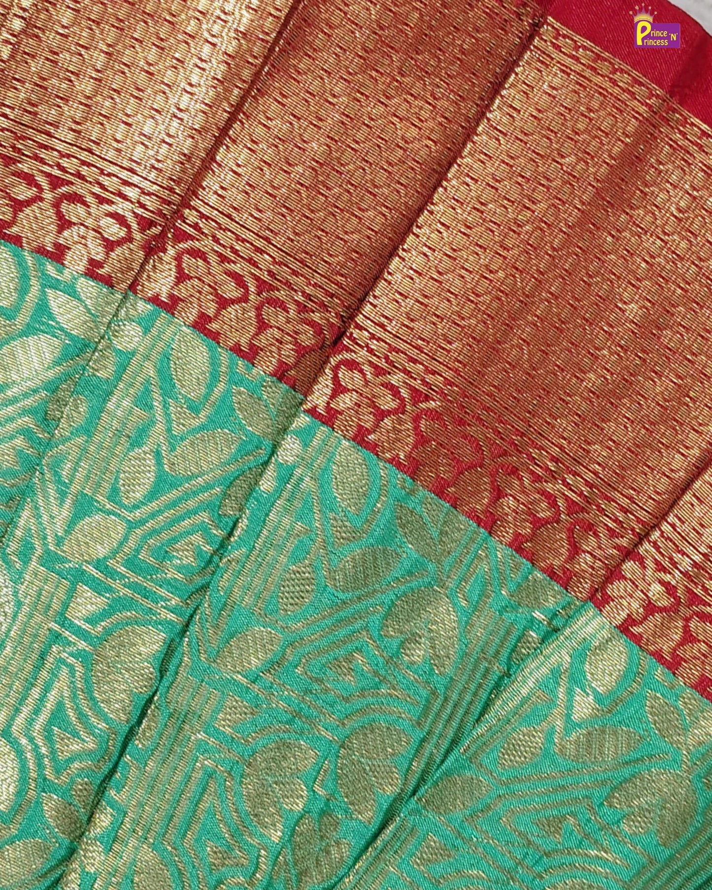 Close-up of a saree with green and red patterns