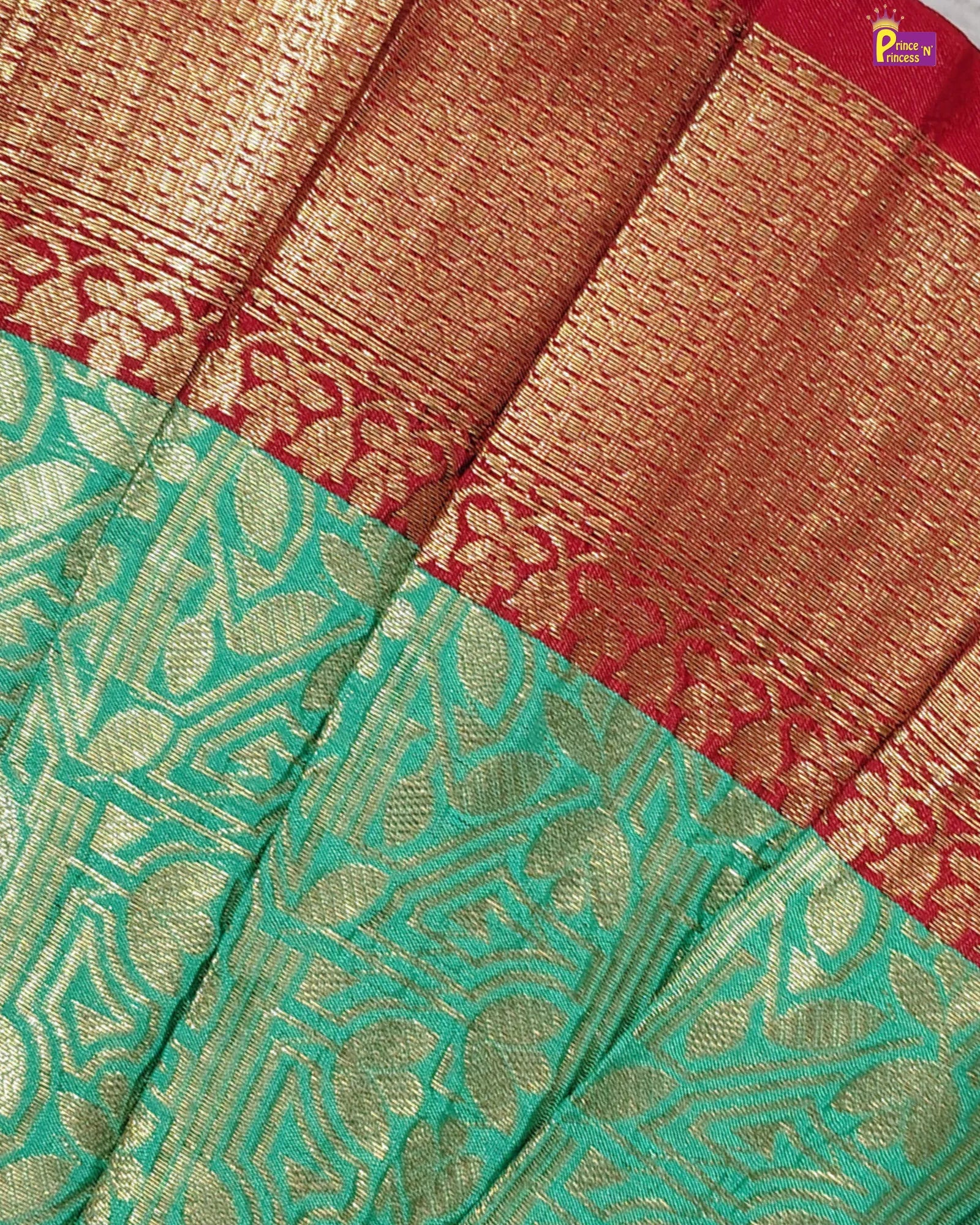 Close-up of a saree with green and red patterns