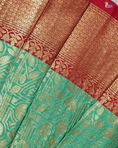 Close-up of a saree with green and red patterns