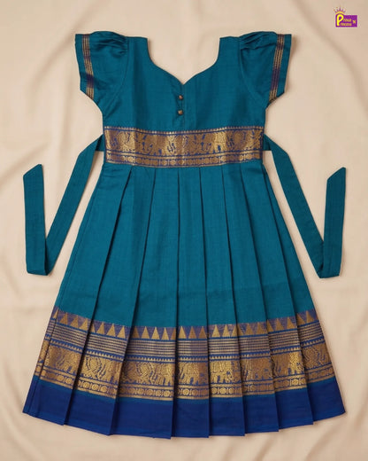 Teal dress with gold elephant patterns on a beige background