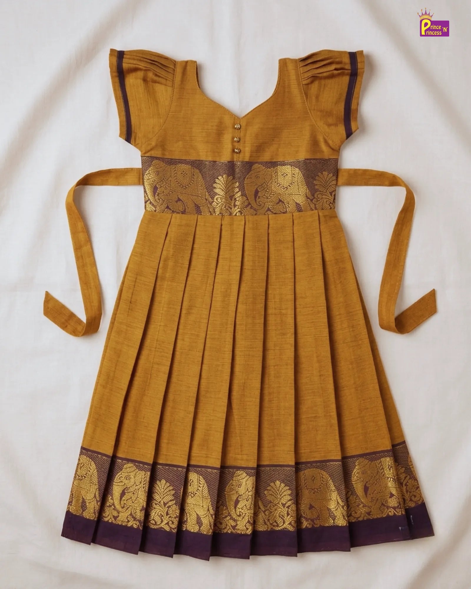Mustard yellow dress with elephant patterns on a white background