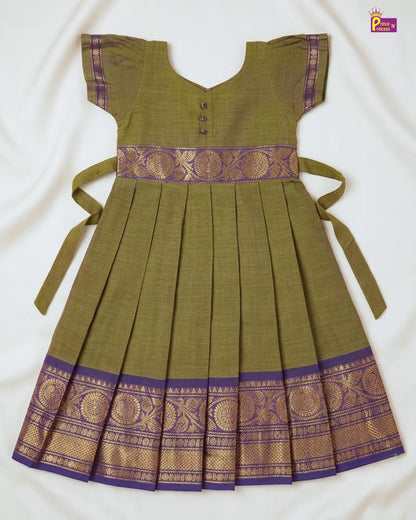 Green dress with purple and gold accents on a white background