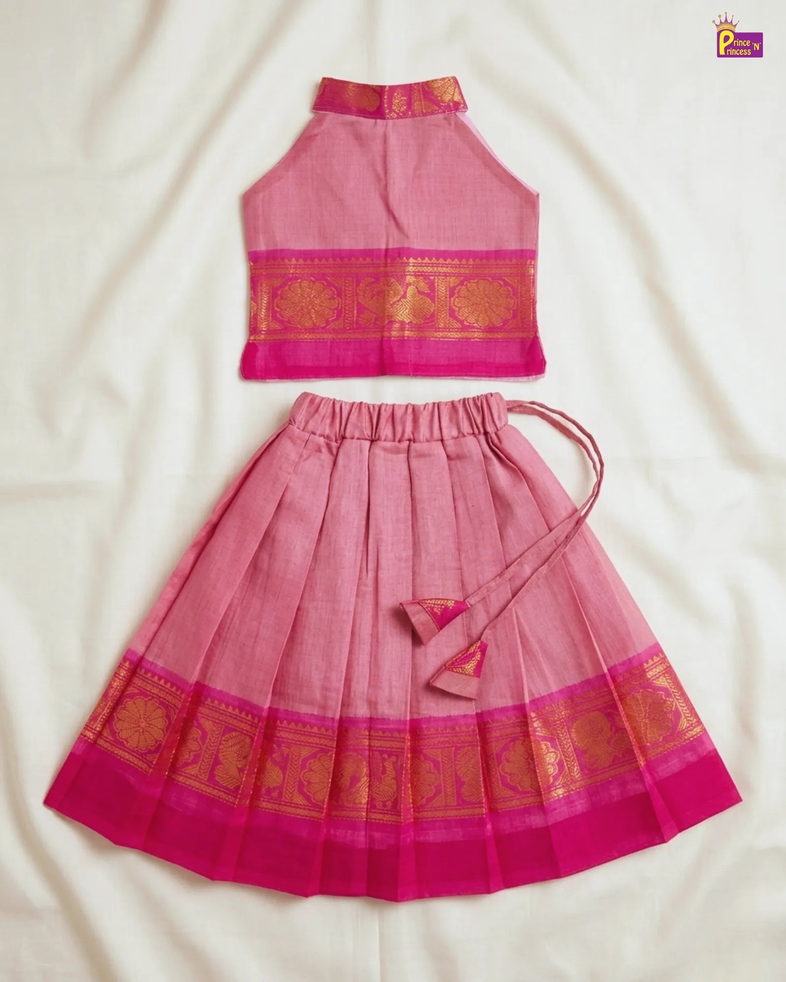 Pink traditional outfit with gold patterns on a white background