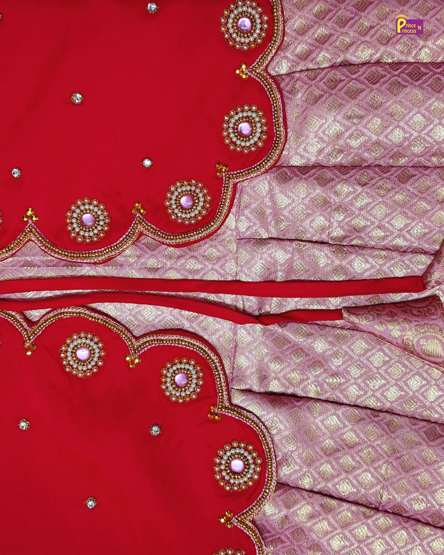 Red and pink saree with intricate patterns and embellishments