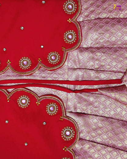Red and pink saree with intricate patterns and embellishments