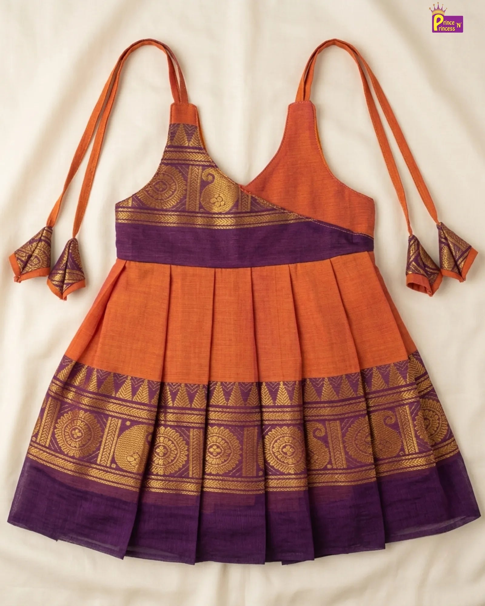 Orange and purple traditional dress with gold patterns on a white background