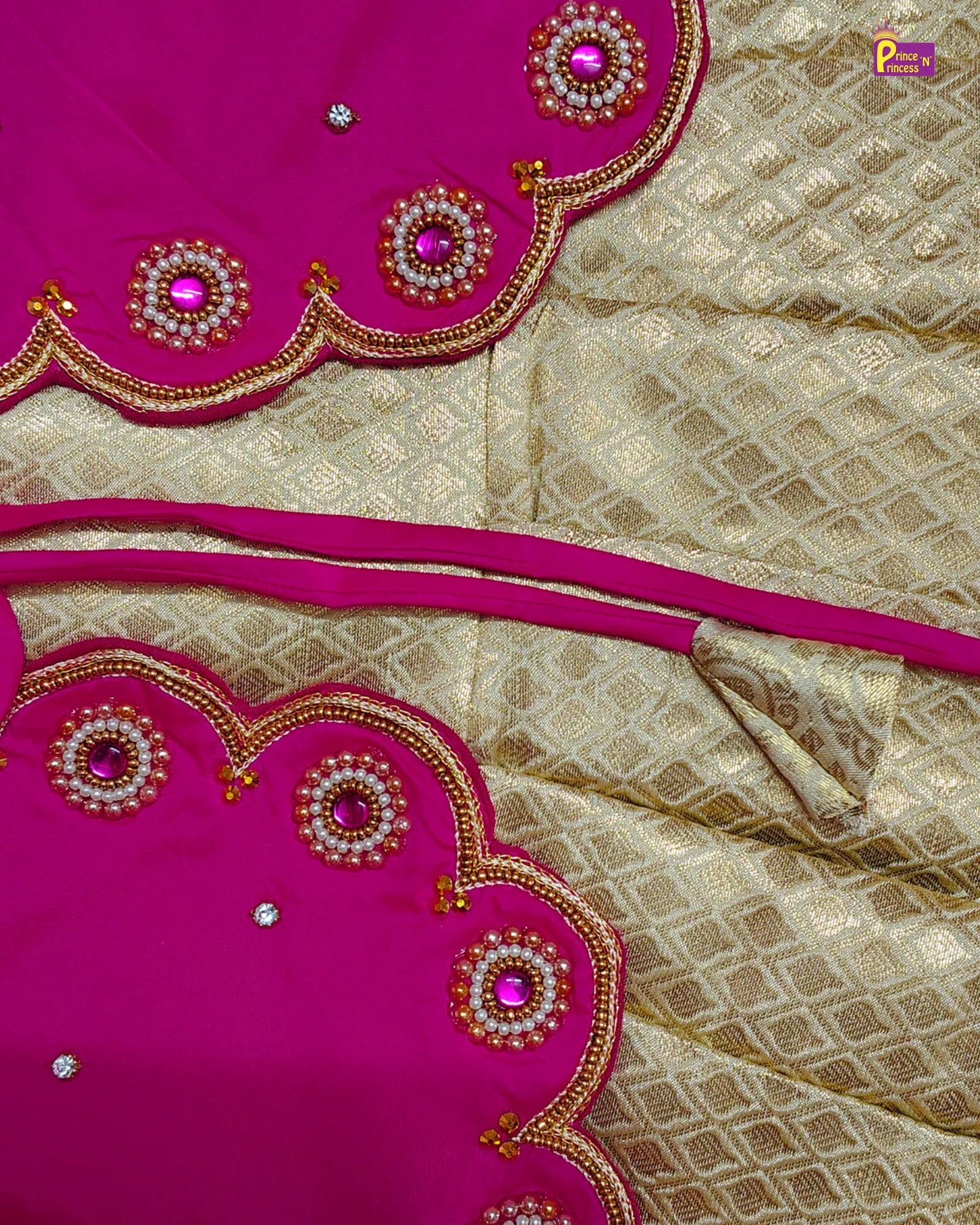 Saree with pink and gold embroidery on a beige fabric background