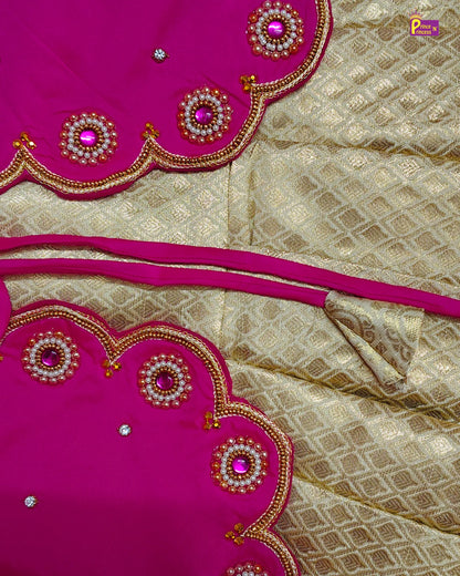 Saree with pink and gold embroidery on a beige fabric background