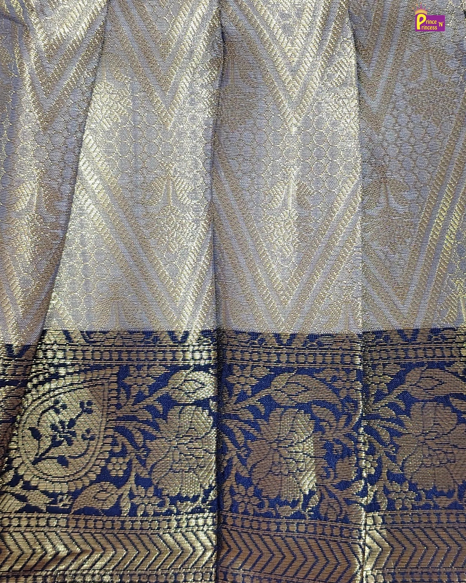 Patterned fabric with geometric and floral designs in blue and gold.