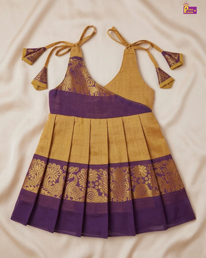 Yellow and purple traditional dress with intricate patterns on a beige background