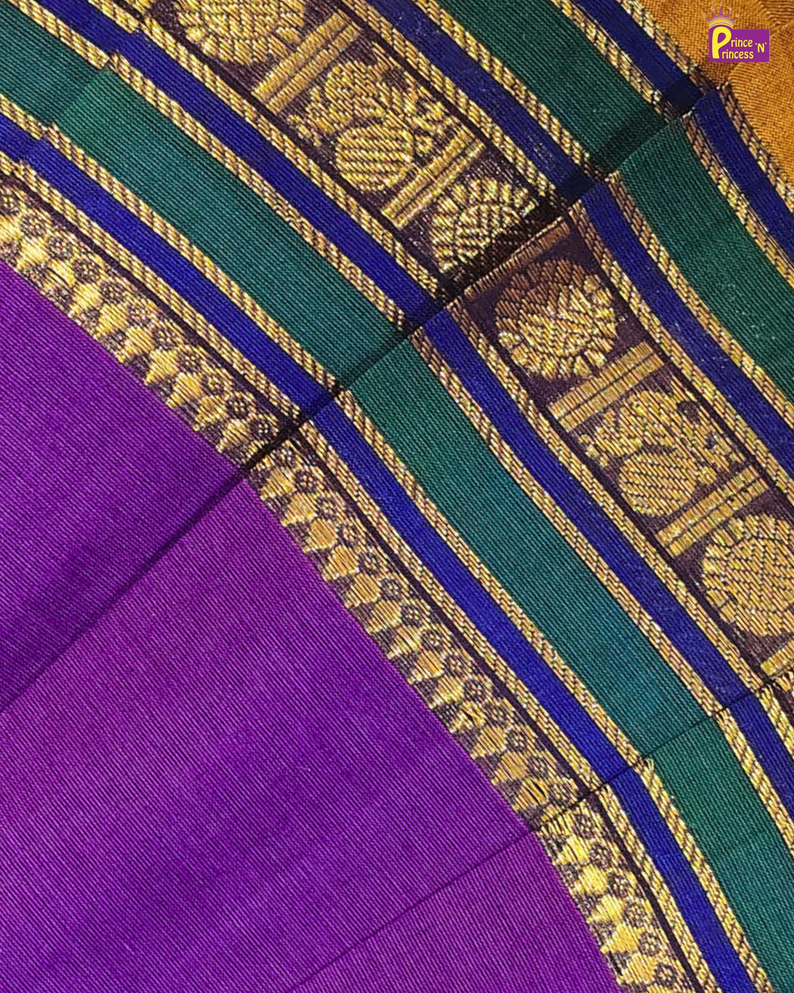 Close-up of a purple fabric with green and gold border