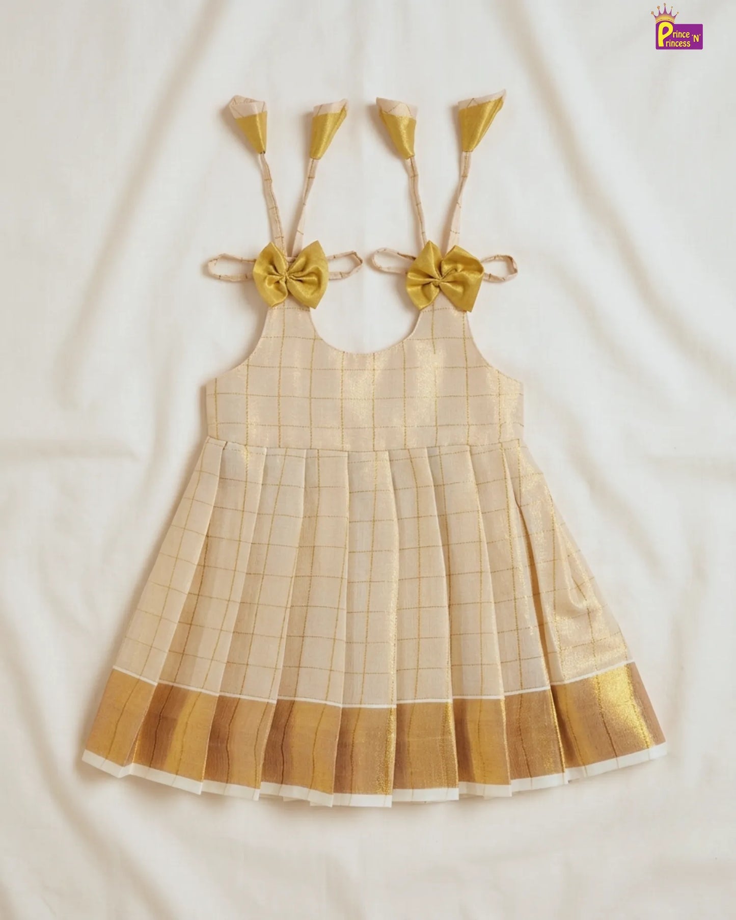 Checkered dress with gold accents on a white background