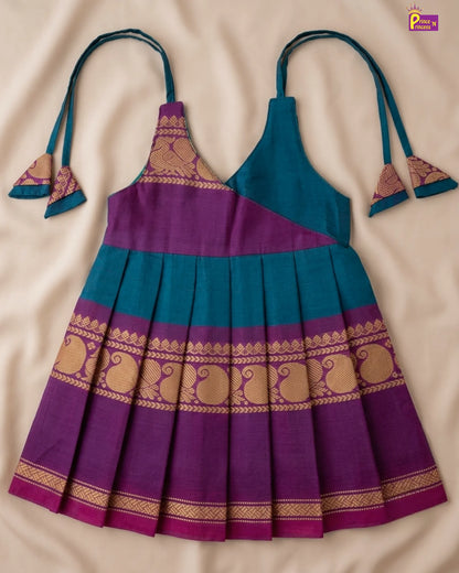 Purple and blue dress with decorative patterns on a beige background