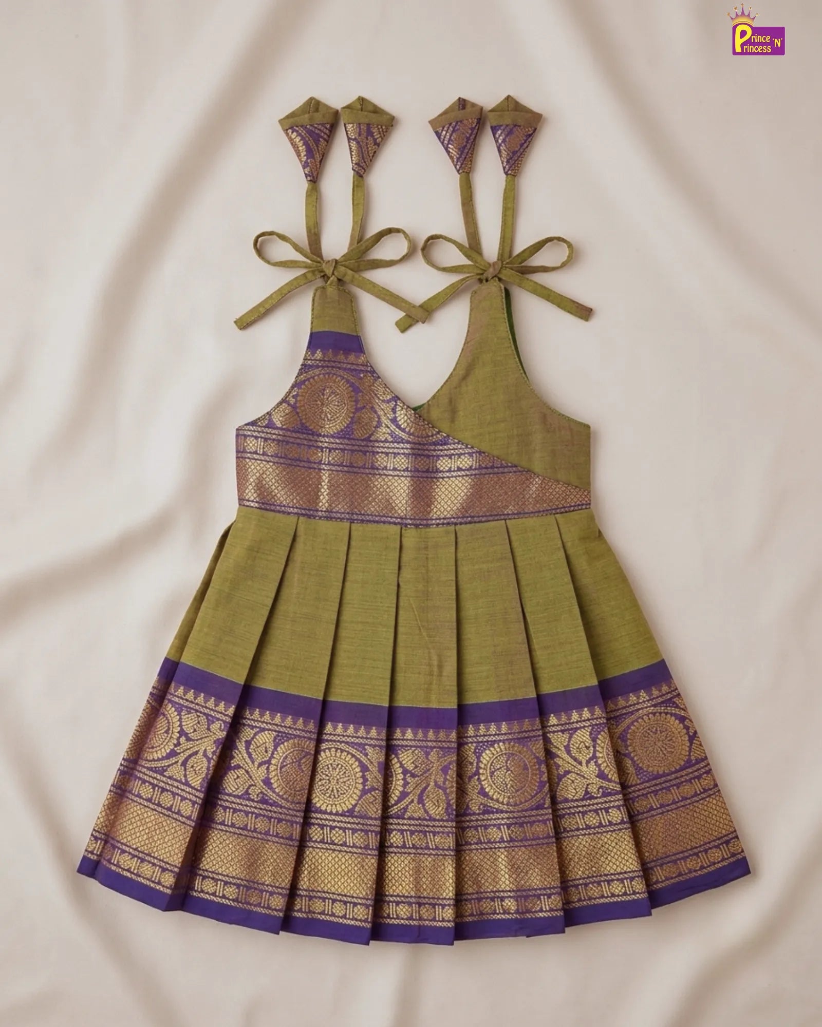 Green and purple traditional dress with intricate patterns on a beige background