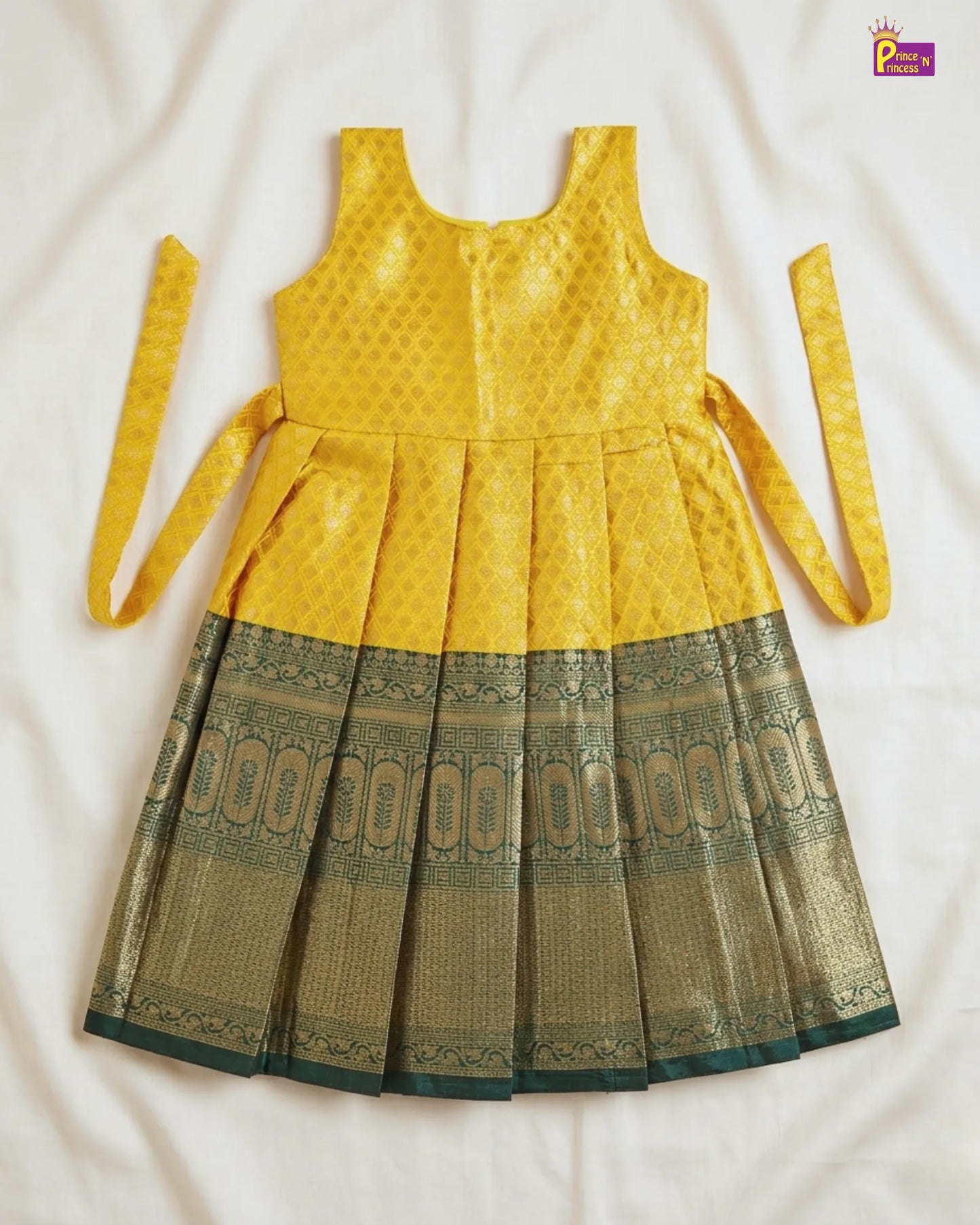 Yellow and green dress with a patterned skirt on a white background