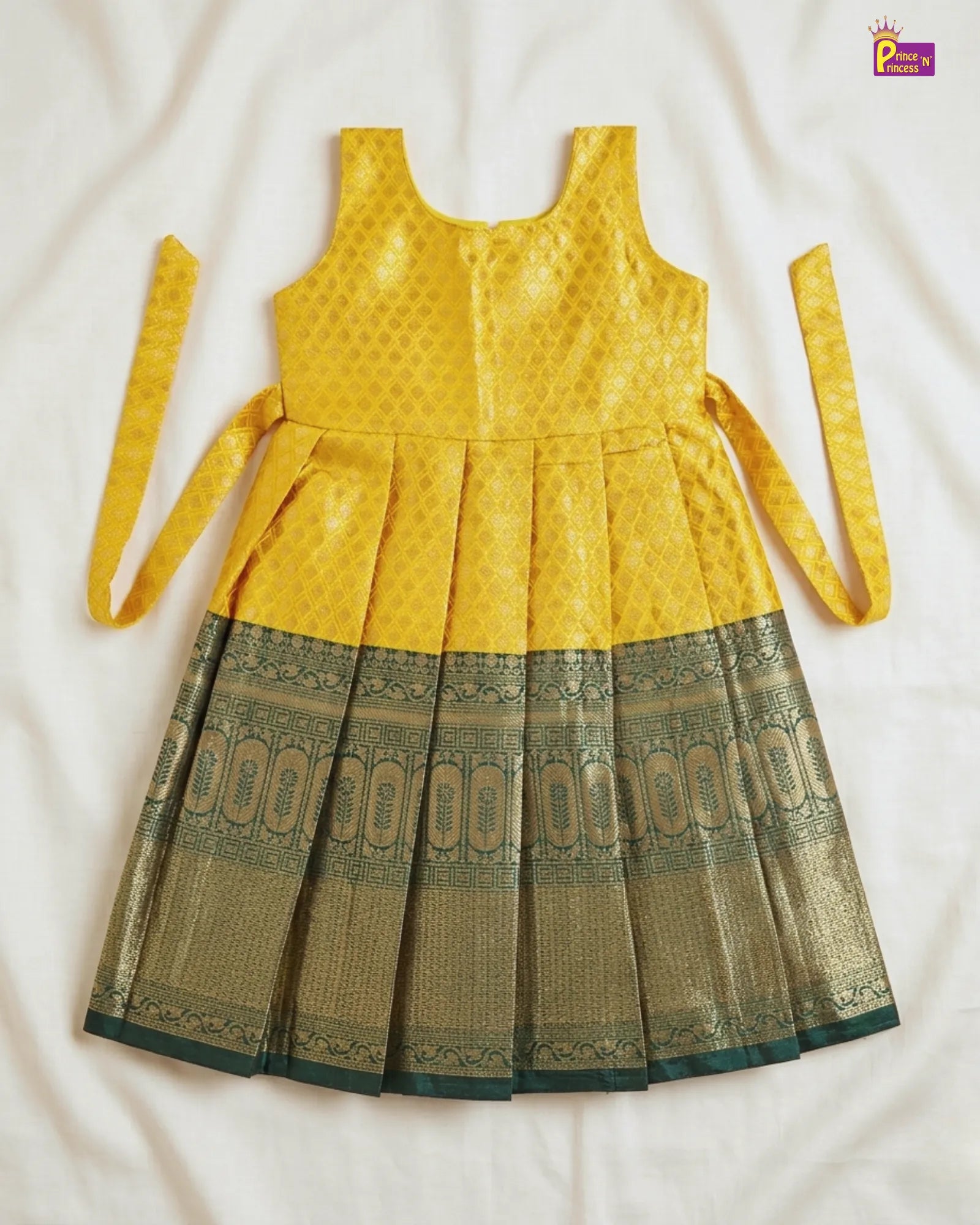 Yellow and green dress with a patterned skirt on a white background