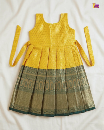 Yellow and green dress with a patterned skirt on a white background
