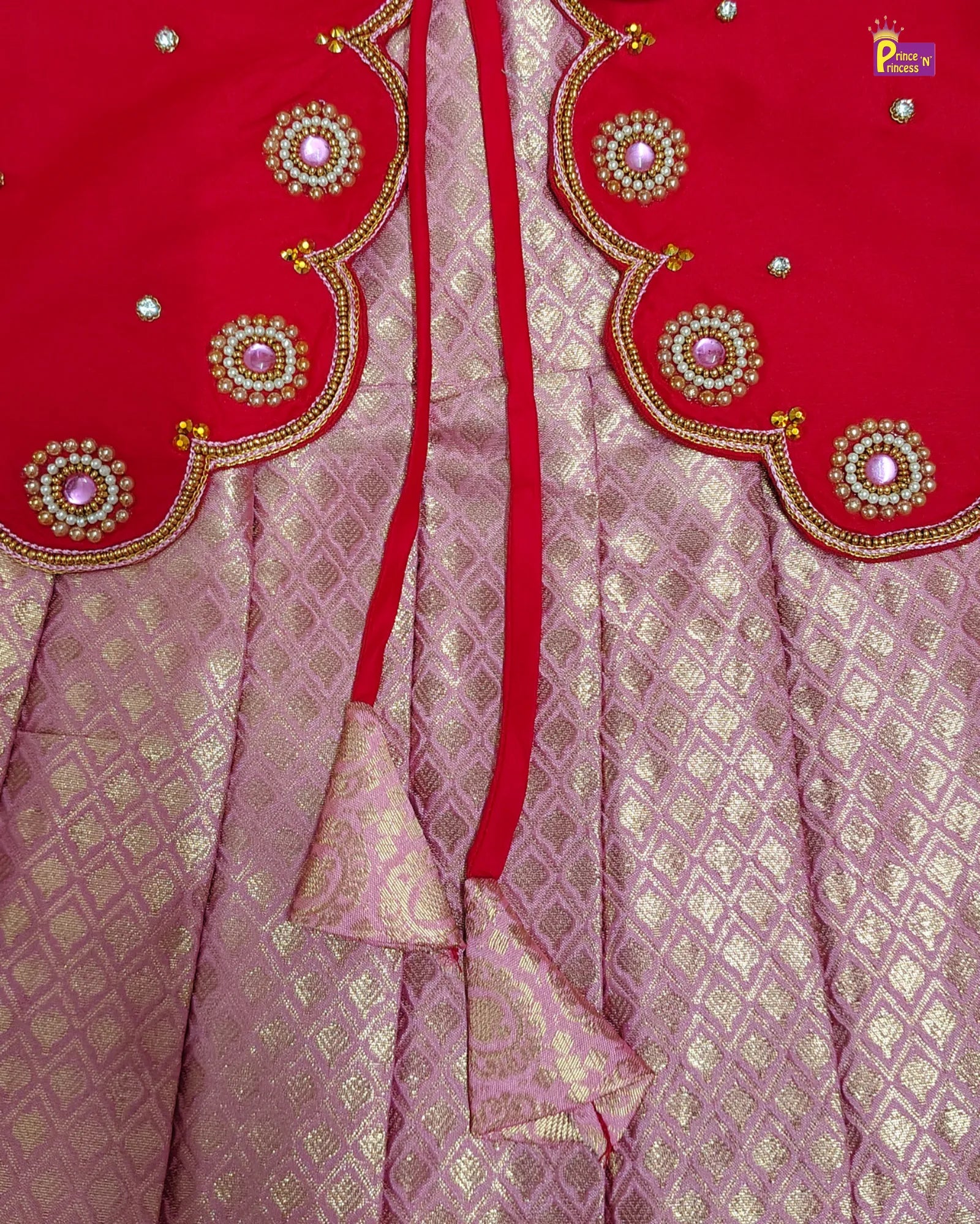 Red and pink traditional fabric with intricate gold embroidery