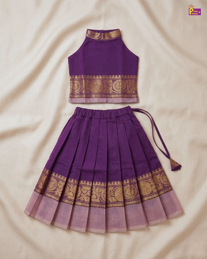 Purple traditional outfit with gold patterns on a beige fabric background