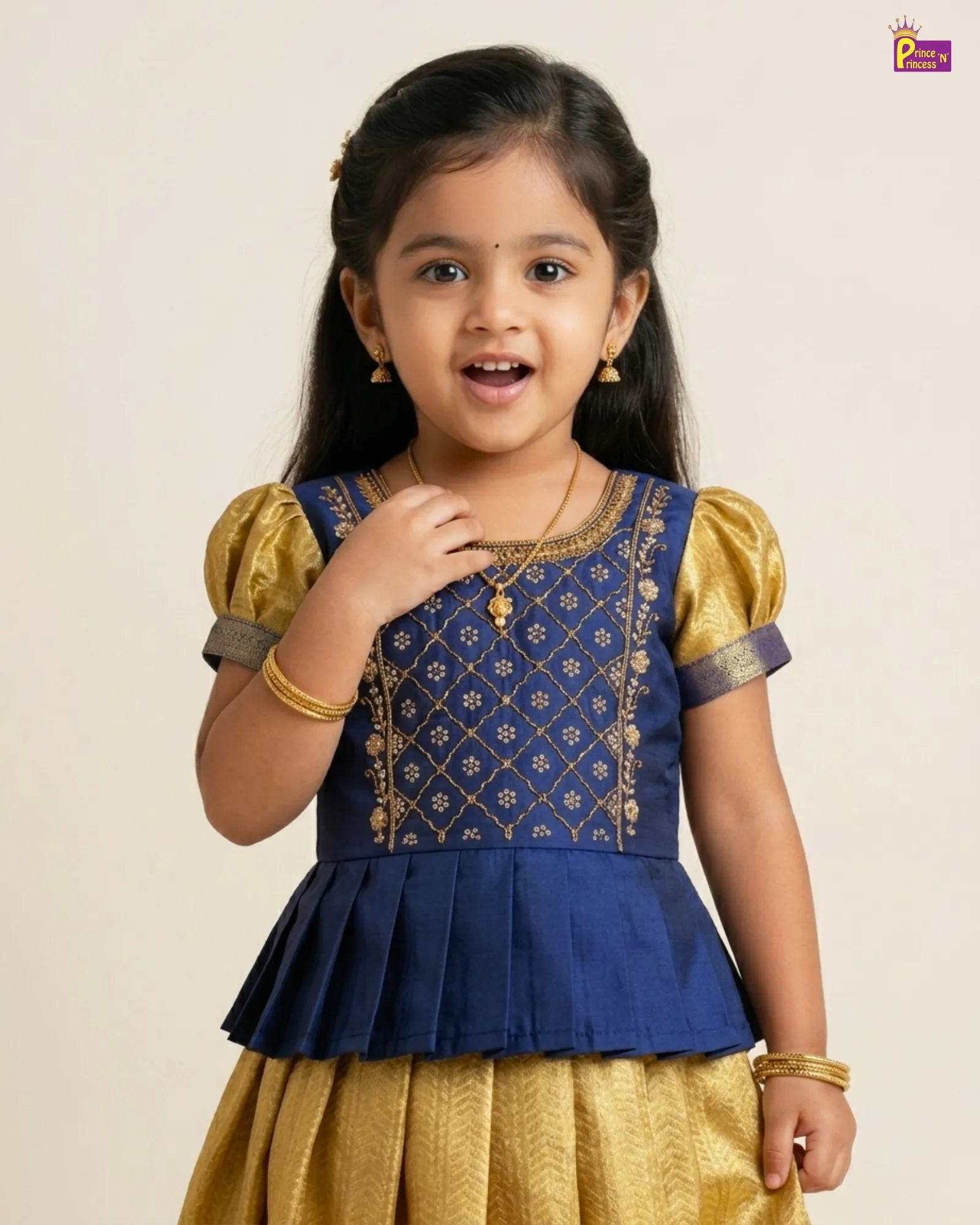 Young girl wearing a blue and gold traditional outfit on a beige background