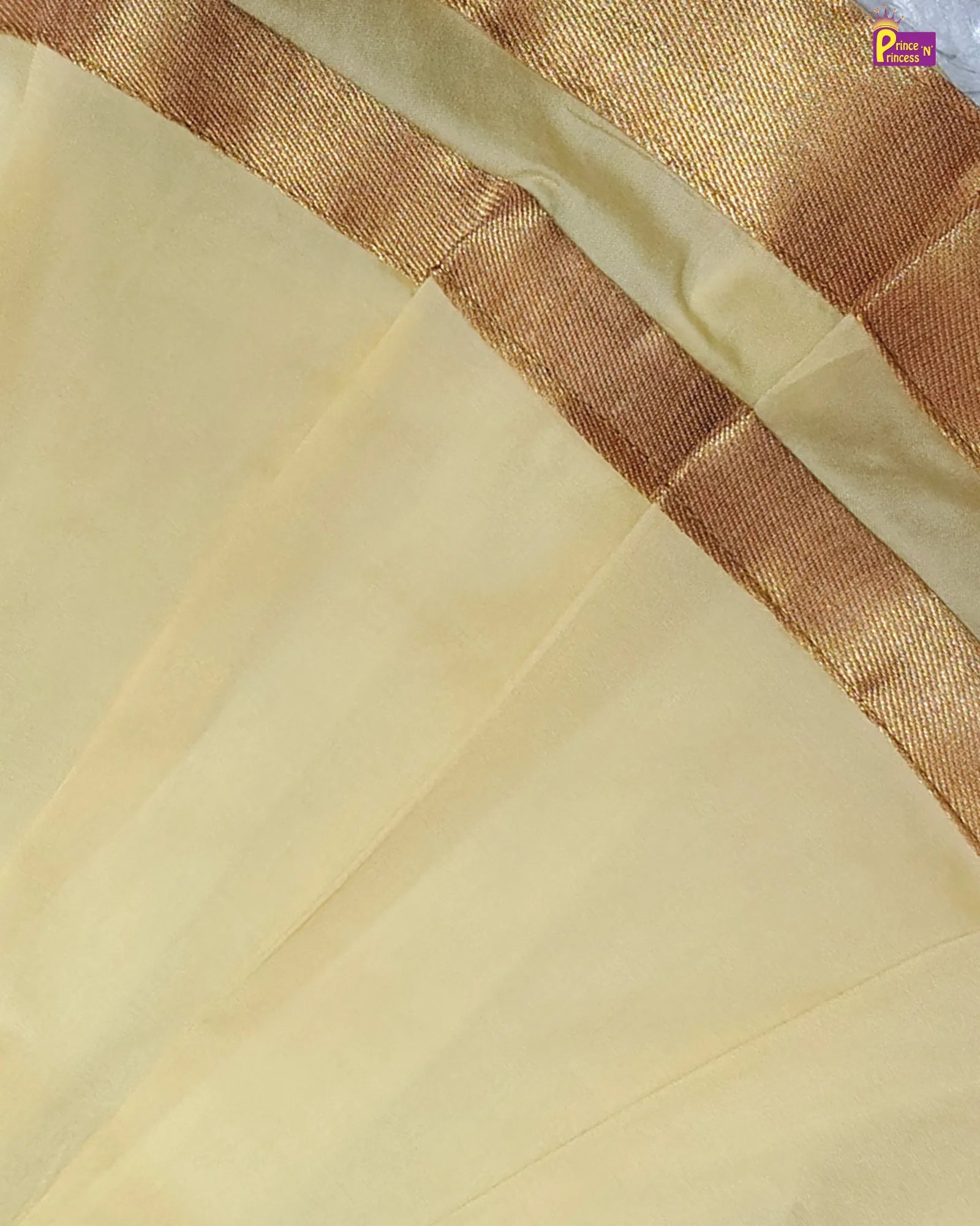 Close-up of a light yellow fabric with a brown border
