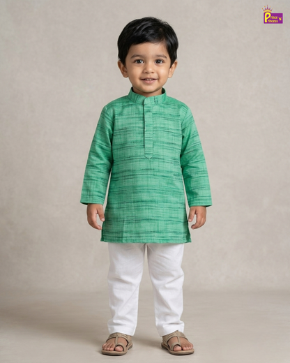 Child wearing a green kurta with white pants on a beige background