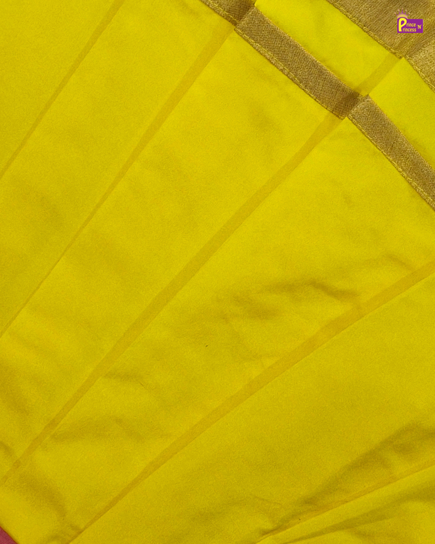 Close-up of a yellow fabric with a gold border