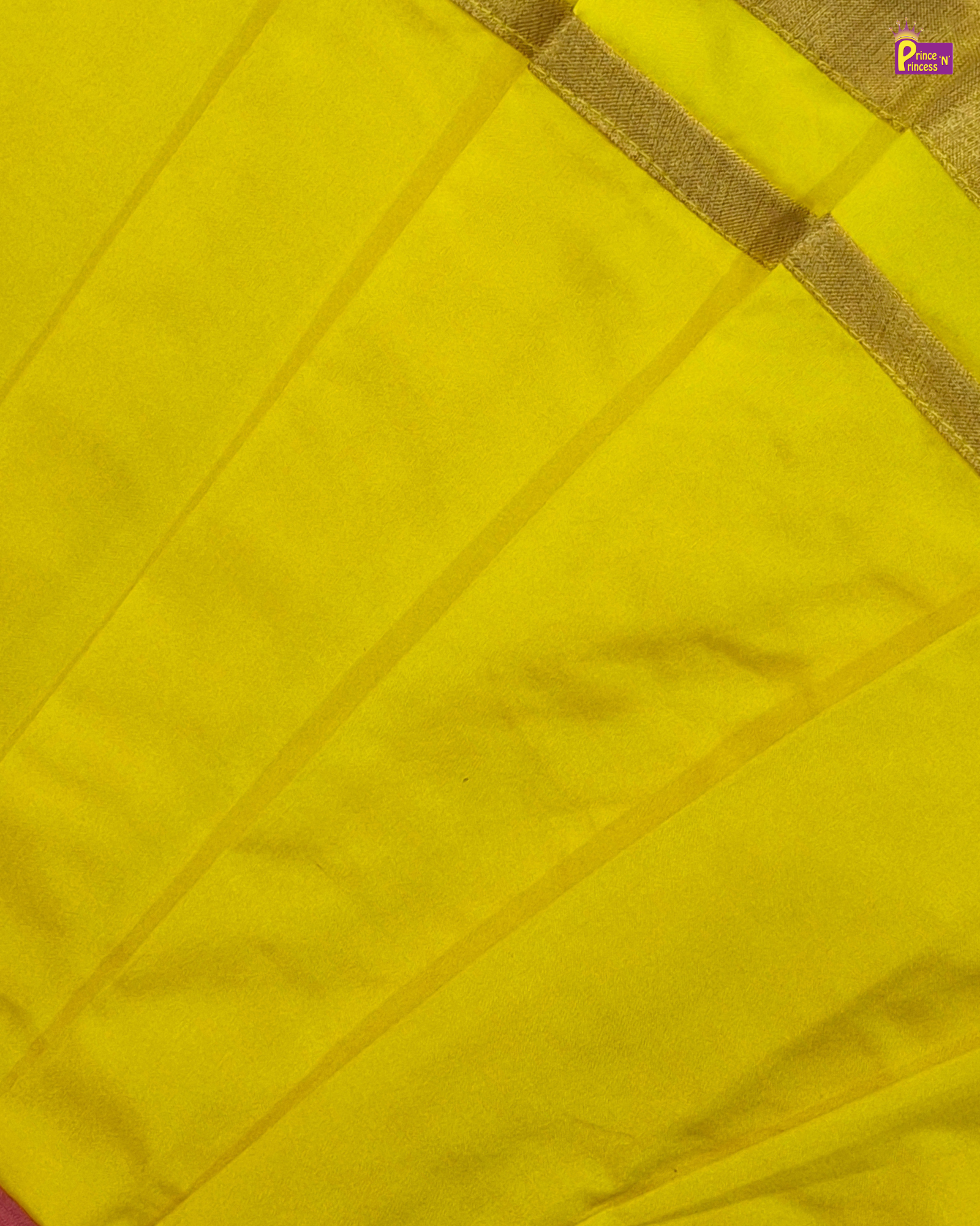 Close-up of a yellow fabric with a gold border