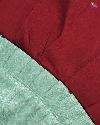 Close-up of maroon and green fabric with a textured pattern