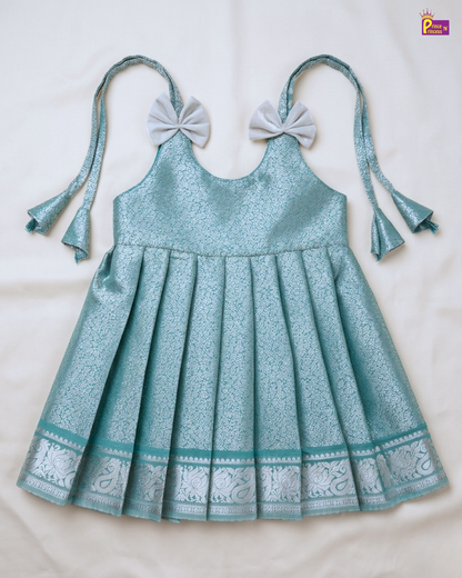 Teal dress with bow straps on a white background