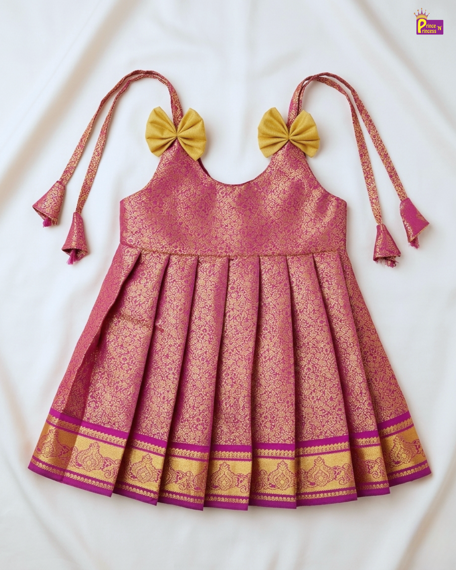 Pink and gold traditional dress with bow straps on a white background