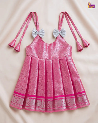 Pink dress with decorative bows on a beige background