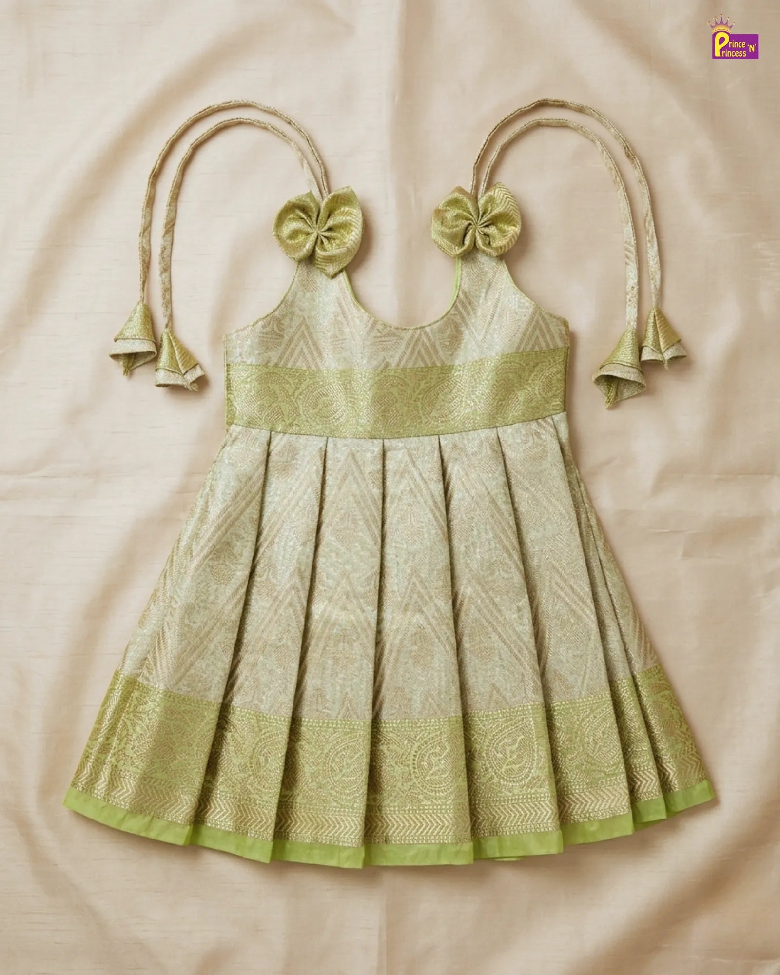 Green and beige dress with decorative elements on a beige background