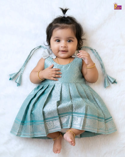 Baby in a light blue dress with decorative elements on a white background