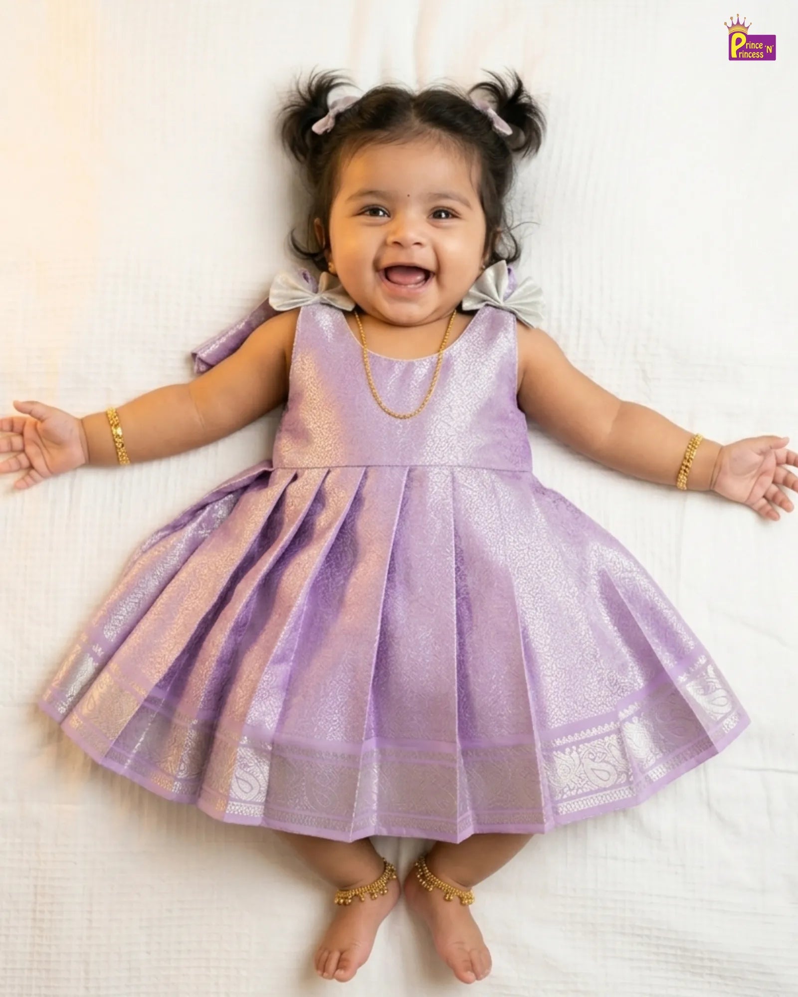 Child wearing a purple dress with a white background