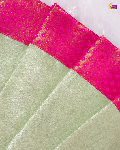 Close-up of a green fabric with pink border featuring diamond patterns.