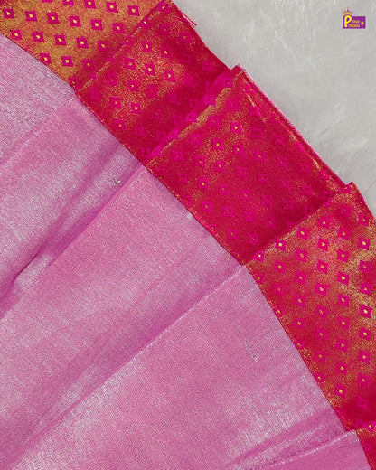 Close-up of a pink fabric with a patterned border on a textured surface