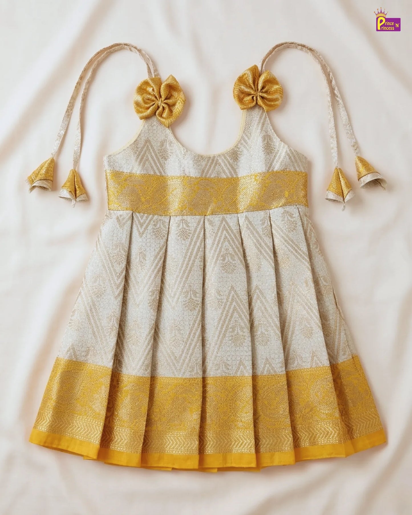 White and yellow traditional dress with floral details on a white background
