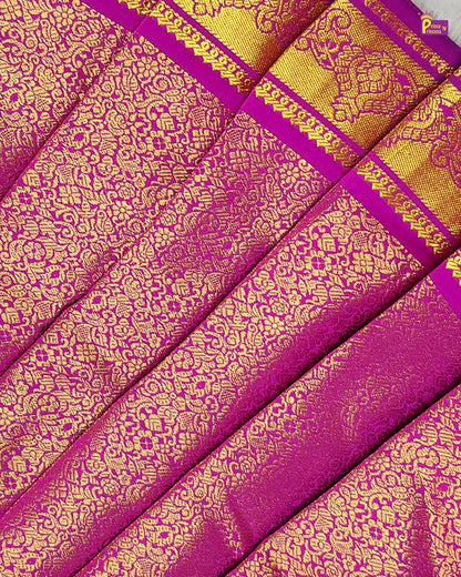 Purple and gold patterned fabric with a brand logo in the corner