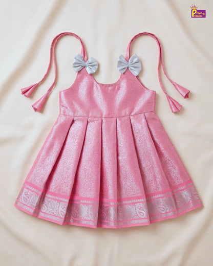 Pink dress with bow straps on a beige background