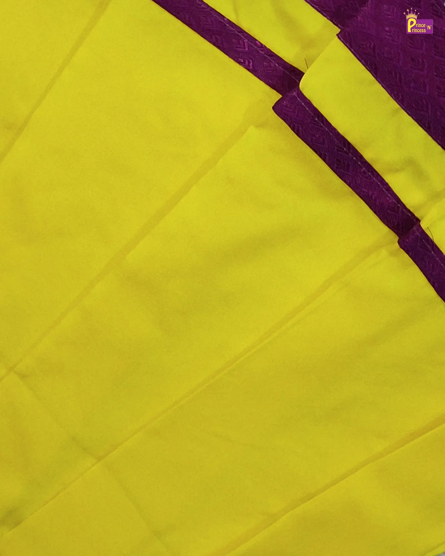 Close-up of a yellow fabric with a purple border