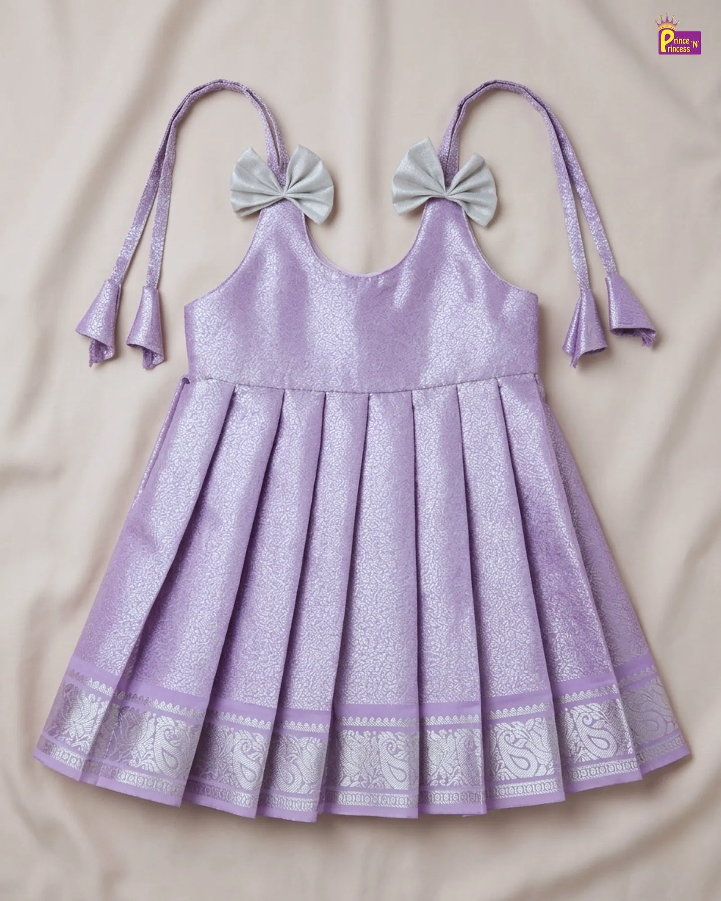 Purple dress with decorative bows on a beige background