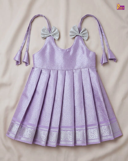 Purple dress with decorative bows on a beige background