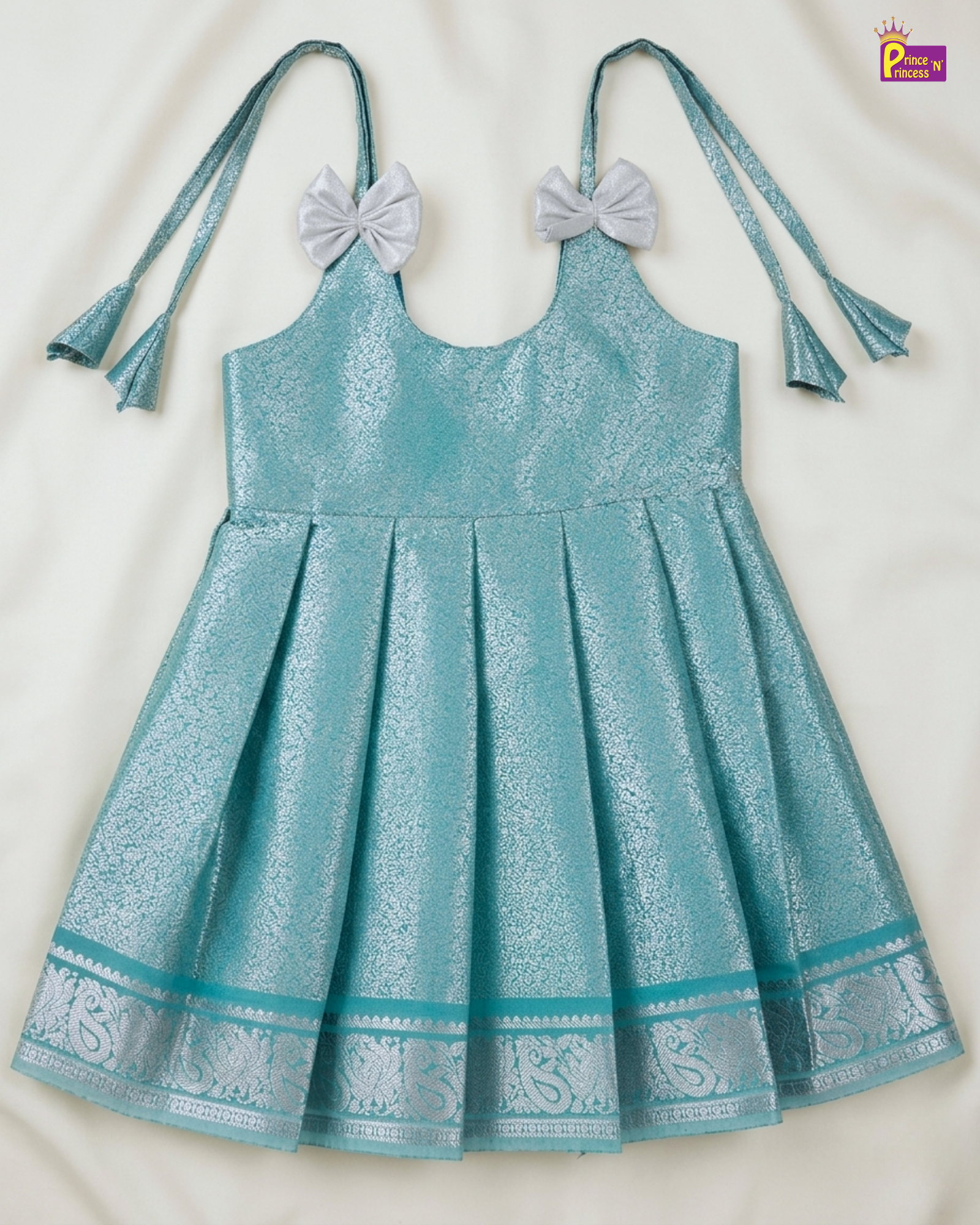 Teal dress with decorative elements on a white background