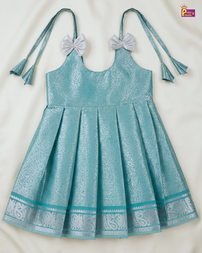 Teal dress with decorative elements on a white background