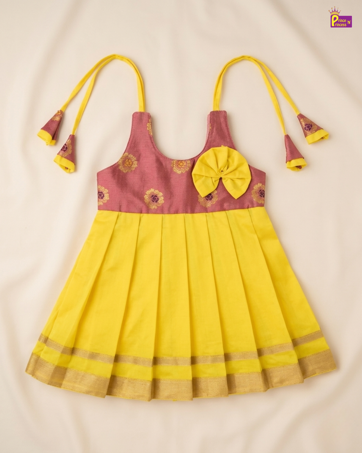 Yellow and pink dress with floral patterns on a beige background